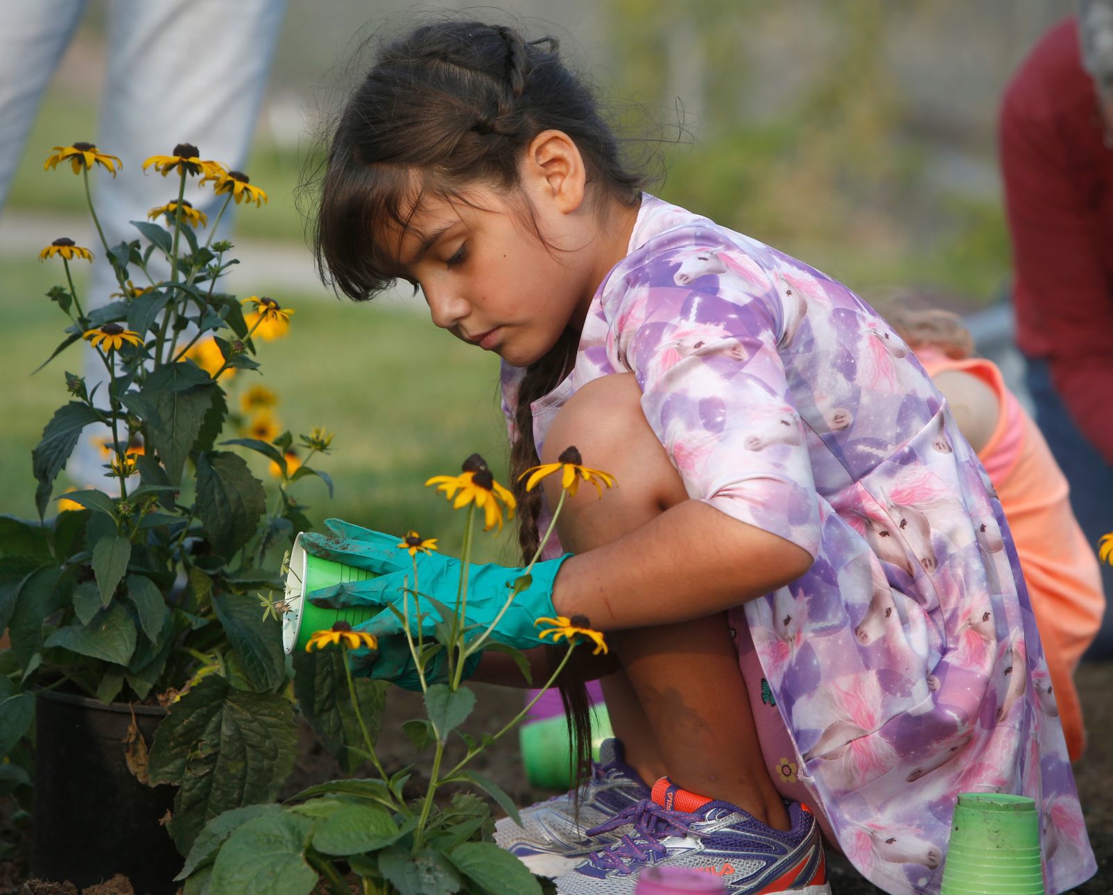 Girl Scouts plant flowers in Billings Depot Pocket Park